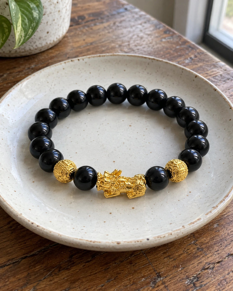 Obsidian beads and gold-plated charm